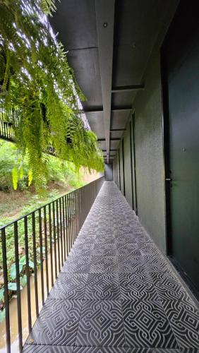 a hallway of a building with a walk way at inchantreemeedao in Ban Chuk Kum
