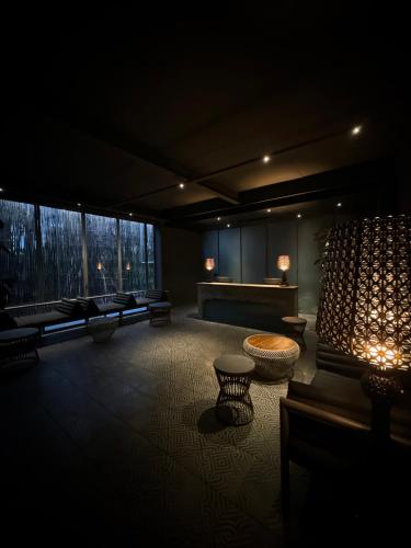 a lobby with tables and chairs in a building at inchantreemeedao in Ban Chuk Kum