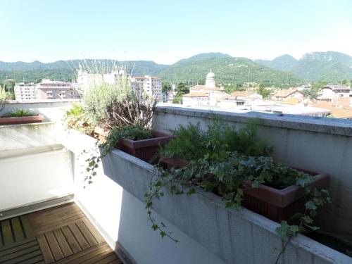 a balcony with plants inpots on a building at Hotel Miramonti in Schio