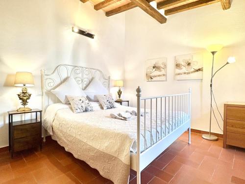a bedroom with a white bed and two lamps at DaLu Florence apartment Lucilla - private car park 15 minutes to the city center in Florence