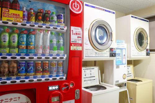 a soda vending machine in a store with drinks at サンホテル大間 in Ōma