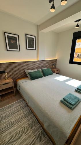 a bedroom with a large bed with green pillows at Mamba Garden III in Calpe