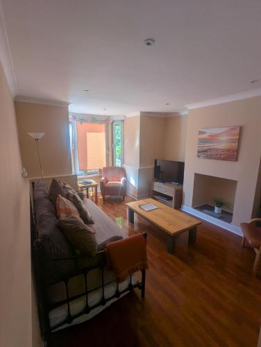 a living room with a couch and a coffee table at 8A Kenilworth Road in Portsmouth