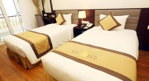 a hotel room with two beds in a room at Lenid Hotel Tho Nhuom in Hanoi