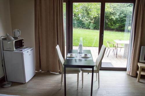 a dining room table with chairs and a microwave at Budget Flats Brussels in Brussels