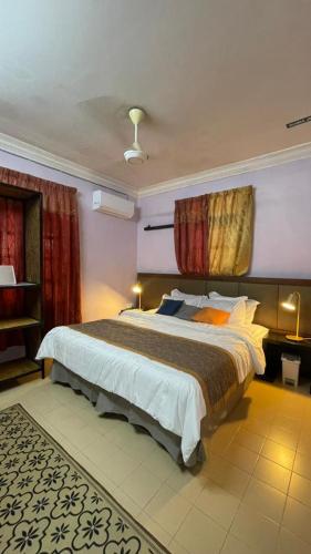 a bedroom with a large bed in a room at Malaika Homestay in Alor Setar