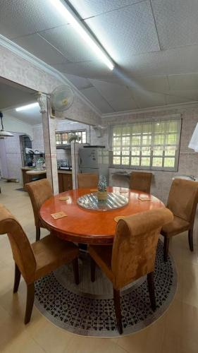 a dining room table and chairs in a kitchen at Malaika Homestay in Alor Setar