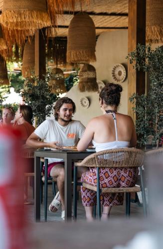 a man and a woman sitting at a table at Delight Hotel in Ksamil