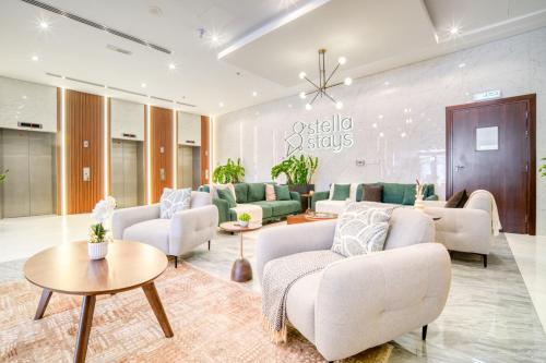 a living room with couches and a table at Stella Stays Lana Tower in Dubai