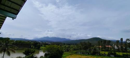 a view of a river with mountains in the background at CKM- Lake View Mountain View and Pool in Chikmagalūr