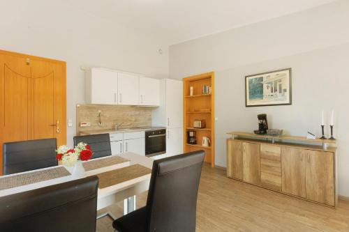 a kitchen with a table and chairs in a room at Ferien im Grünen in Mammelzen