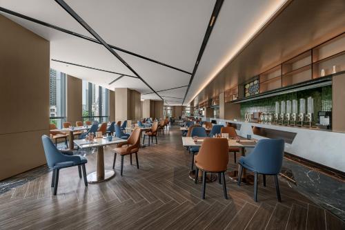 a dining room with tables and chairs at Novotel Kunshan East in Kunshan