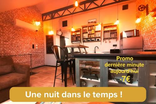 a living room with a kitchen with a counter top at Factory, appart hotel Valenciennes in Aulnoy