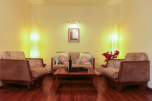 a living room with two couches and a table at Hotel Polo Towers Shillong in Shillong