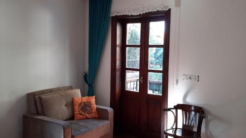 a living room with a chair and a door at Sibel Hotel in Antalya