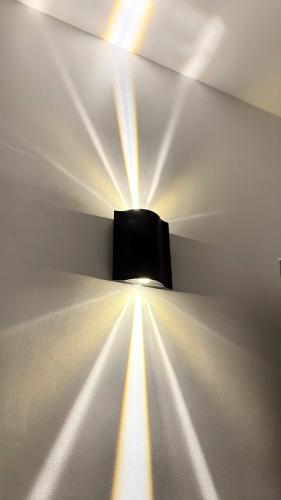 a room with a light on the wall at Hà Tiên Hạnh Phúc Hotel in Ha Tien