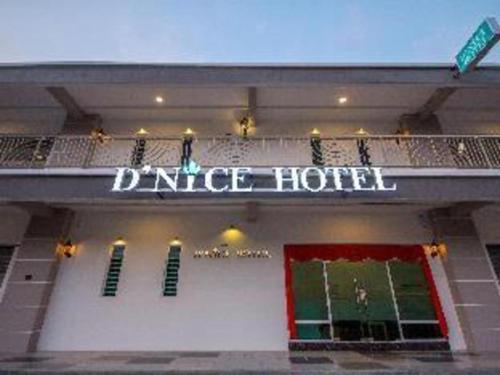 a close up of a dance hotel sign on a building at D Nice Hotel in George Town