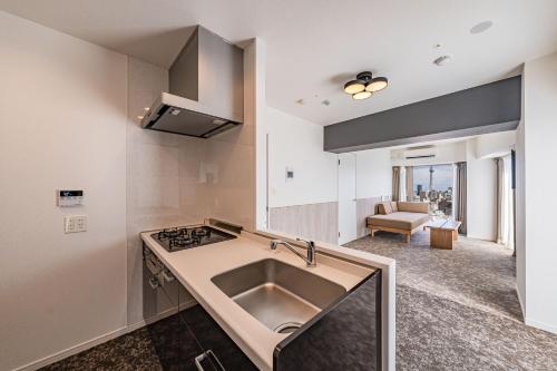 a kitchen with a sink and a stove at Apartment Hotel 11 Asakusa 1 in Tokyo