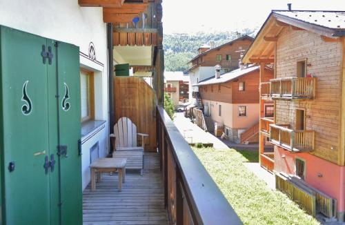 a balcony of a building with a bench on it at Hotel Posta in Livigno