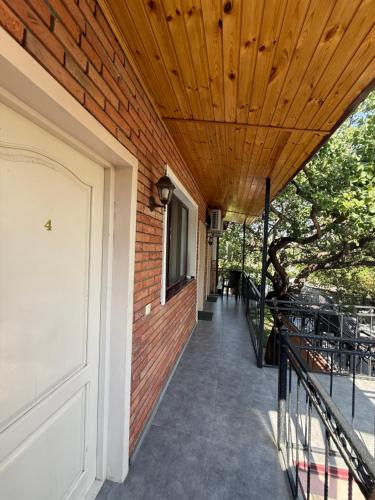 a porch of a house with a wooden ceiling at Emis Hotel in Tbilisi City