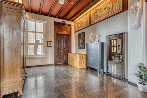 a living room with a wooden ceiling and a refrigerator at Edam Suites in Edam