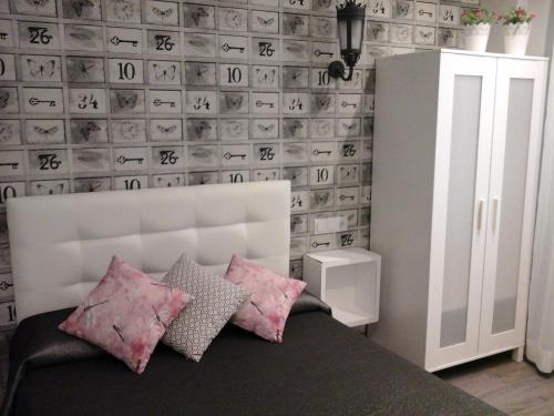 a room with a bed and a wall with numbers on it at Hostal Don Alfonso in Madrid