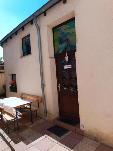a door to a building with a table at Gästehaus Saarbrücken in Saarbrücken