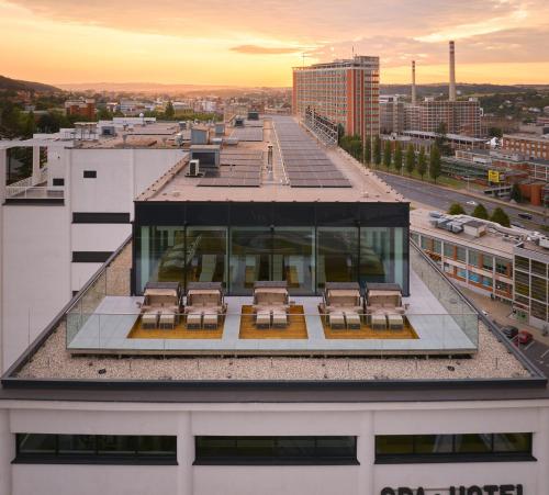 a group of chairs on the roof of a building at Hotel Prior & Energy Spa in Zlín