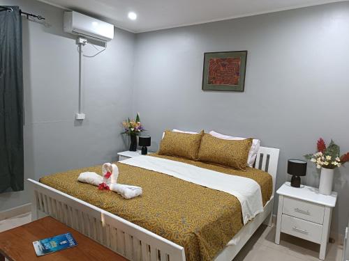 a bedroom with a bed with a stuffed animal on it at Vila Backpackers in Tatafo