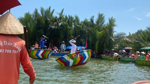 a group of people on boats in the water at Rice River Villa - Hoi An in Hoi An
