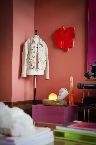 a mannequin in a room with a red wall at De L’Europe Amsterdam – The Leading Hotels of the World in Amsterdam