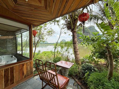 a porch of a house with a table and chairs at Xuan Son Lakeside Bungalow in Ninh Binh