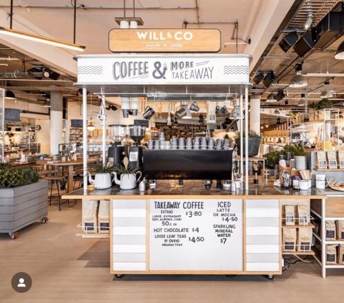 a coffee shop with a sign above a counter at Coastal Comfort In The Heart Of Coogee in Sydney