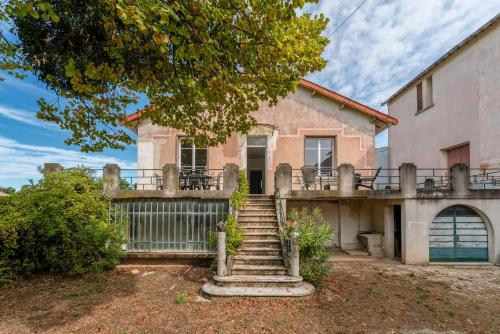 an old house with a staircase leading up to it at Villa Costebelle in Tulette