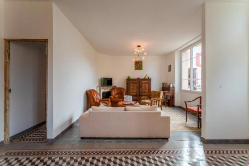 a living room with a couch and a table at Villa Costebelle in Tulette
