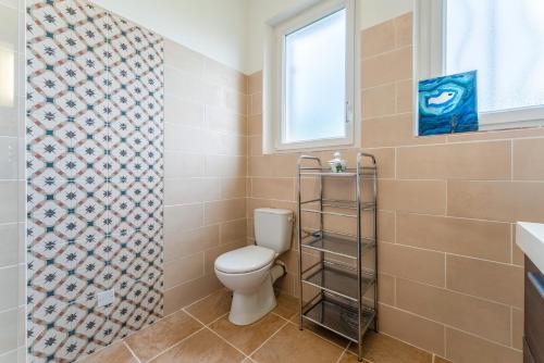 a bathroom with a toilet and a window at Villa Costebelle in Tulette
