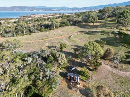 an aerial view of a house in a field at Moon Bay Cabin by Tiny Away in South Arm
