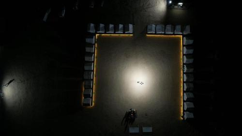 a person standing in a pool in the dark at Retreat Riyasat Desert Camp in Kūri