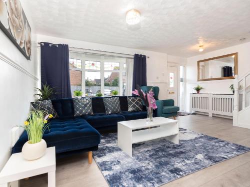 a living room with a blue couch and a table at Prime House in Middlesbrough