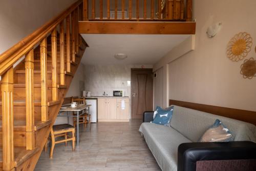 a living room with a couch and a staircase at Villa Veselina Loft Studios in Hisarya