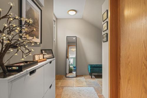 a hallway with a console table and a mirror at Cosy Haven Apartment in Reykjavík