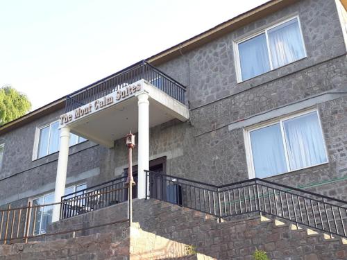 a brick building with a sign in front of it at The Mont Calm Suites in Dargai