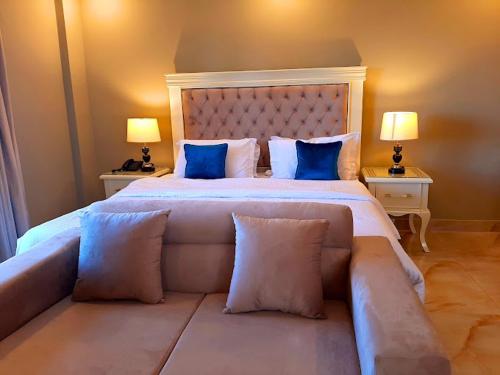 a bedroom with a large bed with blue pillows at The Mont Calm Suites in Dargai