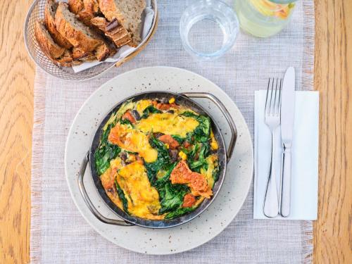 a bowl of food on a table with a plate of food at Hotel Prior & Energy Spa in Zlín