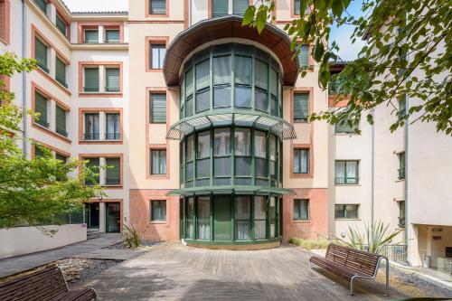 a tall building with a green window at Residhotel Toulouse Centre in Toulouse