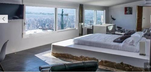 a bedroom with a large bed and a large window at Villa Hawai in Benidorm