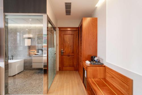 a bathroom with a shower and a sink at Le Saigon Grand Hotel in Ho Chi Minh City