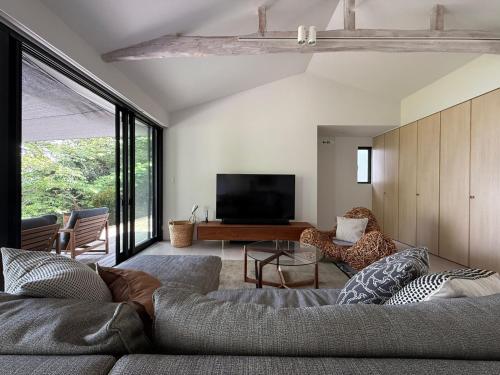a living room with a couch and a television at VILLA PINECOVE - Vacation STAY 24656v in Kamogawa