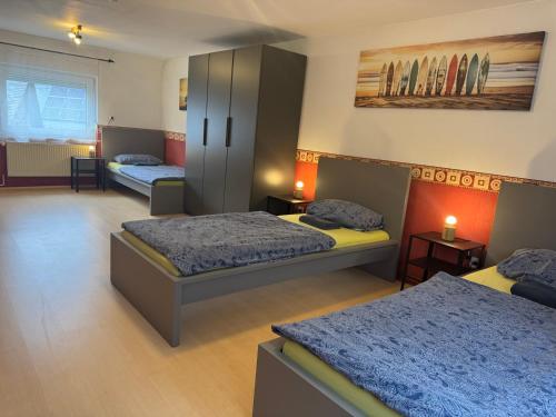 a bedroom with two beds and a cabinet at Rhaunen Gasthaus in Rhaunen