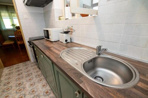 a kitchen counter with a sink and a microwave at House Bianca with garden in Malinska
